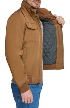 stay cozy in style when you wear this must-have jacket that's designed with a nifty packable hood. 30" length (size M) Packable hood Long sleeves Front zip closure Chest patch pockets Front snap pockets Quilted lining 100% polyester Machine wash, tumble dry Imported Model stats: 6'0" height; 32" waist. Model is wearing size M. Fall Travel Windbreaker With Pockets, Utility Nylon Outerwear With Fleece Lining, Travel Nylon Hooded Jacket With Pockets, Nylon Hooded Travel Jacket With Pockets, Travel Hooded Jacket With Pockets In Nylon, Travel Hooded Jacket In Nylon, Nylon Hooded Jacket For Fall Travel, Travel Hooded Jacket With Pockets, Fall Travel Nylon Hooded Jacket