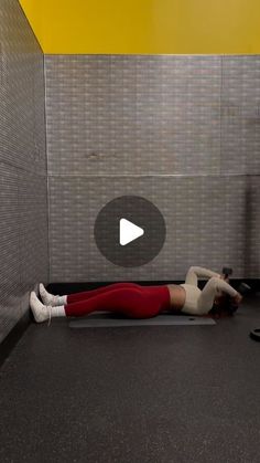 a woman laying on the ground in a bathroom