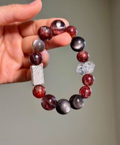 "Size: 11-14mm Material:  Hematoid Fire Quartz, Herkimer Diamond, Silver Sheen Obsidian, Peach Moonstone, 925 Sterling Silver Accessory Step into a world of natural beauty with my handcrafted gemstone bracelet!  🔥Hematoid Quartz promotes a serene mind, fostering improved thought patterns and heightened empathy. Enjoy its skincare benefits and radiate a healthy glow with regular wear. 💎Herkimer Diamond enhances spiritual awareness, achieve mental clarity, and nurture a calm and resolute consciousness. ✨Known as the \"lover's stone,\" Peach Moonstone softens the soul, fostering emotional serenity and alleviate communication-related conflicts, radiate charm, and exude a gentle aura. Embrace the magic of nature's gems and experience a blend of style and holistic well-being.  Only ONE availab Agate Gemstone Beaded Bracelets As Gift, Hand-strung Agate Crystal Bracelet As Gift, Silver Agate Stretch Bracelet, Fusion Style Beaded Bracelet Gift, Sterling Silver Fusion Beaded Bracelets For Gifts, Sterling Silver Fusion Beaded Bracelets As Gift, Fusion Style Polished Beaded Bracelets As Gift, Fusion Style Round Beaded Bracelets As Gift, Fusion Style Polished Beaded Bracelets For Gifts