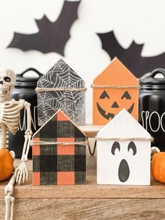 halloween decorations with pumpkins, jack - o'- lanterns and skeletons on a table