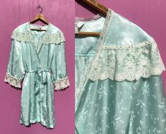 Vintage Aqua Blue Satin Robe with Lace Trim and Belt Pretty wrap robe has a Victorian style lace shoulder trim, lace at the sleeves and along the front edges. Closes with a tie belt and has two set in pockets! CONDITION: Good with light wear. NOTE that the belt has several snags in the fabric. LABEL: TJW by Mervyn's, made in Korea FABRIC:  100% Polyester SIZE: Marked Small but it is ALWAYS best to check measurements: Underarm to Underarm, across the front: 25" Bust fit: up to about 40" Waist: up to 48" Length: 37.5" CHECK measurements CAREFULLY! If it doesn't fit, I will accept returns of clothing in the same condition it was sent out, including perfume odors, buyer pays shipping both ways.  For more vintage lingerie, look here: https://www.etsy.com/shop/AllsFairyVintage?ref=condensed_trus Spring Vintage Sleepwear With Lace Trim, Fitted Vintage Sleepwear With Lace Trim, Vintage Lace Sleepwear For Spring, Victorian Wrapper, Womens Lingerie, Vintage Lingerie, Blue Satin, Victorian Style, Tie Belt