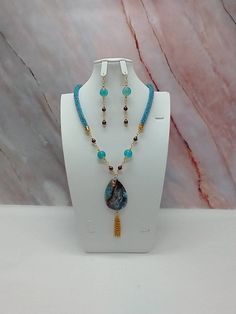 "Handmade and designed by me-one of a kind necklace set-rainbow turquoise seed bead crocheted rope necklace-23\" long-4\" long focal with a fire agate pendant bead and a 1 1/2\"  long chain tassel-brown glass pearls-glass beads-metal beads-2 3/4\" long matching dangle earrings- -gold tone findings-hook and eye clasp. This is a beautiful and unique necklace set! Has a hook and eye clasp so it is easy to put on!" Turquoise Dangling Beads Costume Jewelry, Turquoise Costume Jewelry With Dangling Beads, Unique Teardrop-shaped Jewelry With Colorful Beads, Unique Teardrop Jewelry With Colorful Beads, Adjustable Gemstone Beaded Dangle Necklaces, Teardrop Colorful Beads Jewelry For Gifts, Artisan Dangle Beaded Chain Jewelry, Artisan Beaded Chain Dangle Jewelry, Artisan Dangle Beaded Jewelry