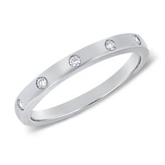 This 14K Gold Bezel & Channel Set Ring is a masterpiece of elegance. Featuring 0.06 carats of sparkling diamonds, the ring is designed with a seamless blend of bezel and channel settings that showcase the diamonds' brilliance while ensuring a sleek, modern look. The diamonds are meticulously placed to create a subtle yet captivating sparkle that catches the eye. Available in 14K white, yellow, or rose gold, this ring is perfect for stacking or wearing alone as a refined statement piece. Its vers Modern Stackable Rings With Cubic Zirconia, Formal Diamond Jewelry With Smooth Bezel, Formal White Gold Rings With Smooth Bezel, Formal White Gold Ring With Smooth Bezel, Elegant Stackable Rings With Smooth Bezel For Anniversary, Modern Silver Stackable Rings With Single Cut Diamonds, Modern Diamond White Stackable Rings With Single Cut Diamonds, Timeless Diamond Rings With Smooth Bezel, Elegant Anniversary Ring With Smooth Bezel