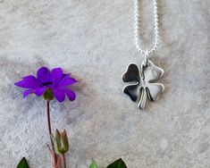 This dainty four-leaf clover charm is sure to bring luck to anyone that wears it! This good luck clover necklace is made of 925 sterling silver. Clover necklace measure: 15.6 in. + 2,4 in extension chain Clover pendant size: 12 x 12.5 mm You can choose the chain: - Ball chain - Rolo chain This necklace is available in: - Gold plated: https://www.etsy.com/listing/675773043/four-leaf-clover-necklace-dainty-gold - Rose gold plated: https://www.etsy.com/listing/744222797/dainty-four-leaf-clover-neck Dainty Flower Pendant Charm Necklace For Good Luck, Dainty Good Luck Flower Pendant Charm Necklace, Silver Necklaces With Flower Charm For Good Luck, Silver Necklace With Flower Charm For Good Luck, Good Luck Clover, 4 Best Friends, Interlocking Circle Necklace, Layered Choker Necklace, Clover Pendant