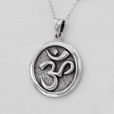 Both the necklace chain and Om Aum pendant are made from pure .925 sterling silver with stamp.  No coatings, no plating, just sterling silver! Embrace the peace and beauty of the Om Aum Ohm pendant with this stunning sterling silver necklace. Crafted from solid .925 sterling silver, this exceptional pendant measures approximately 7/8 inch (23 mm) in diameter, making it a perfect minimalist jewelry piece. Experience the transformative power of the Om with this elegant sterling silver pendant necklace. Crafted from high-quality materials, the intricate Om symbol is a timeless piece that can be worn daily or on special occasions. Perfect for Buddhist practitioners, yoga enthusiasts, or anyone seeking peace and harmony, this necklace is a meaningful addition to any jewelry collection. The adju Cheap Silver Spiritual Necklace, Ohm Jewelry, Ohm Pendant, Aum Symbol, Om Aum, Om Pendant, Buddhist Meditation, Symbol Necklace, Sterling Silver Necklace Pendants