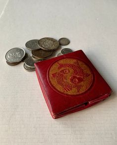 This accordion style vintage coin pouch is from the 1960s. It would make a terrific gift for the fisher or man in your life.  **NO COINS ARE INCLUDED. THEY ARE PICTURED FOR DEMONSTRATION ONLY.** Features:  * This wallet is pre-owned and has slight wear due to age and use.  * Beautiful aged red and orange with fish motif.  * Made of leather.  * Snap closure. * Approximately 3" square.  * Measure approximately 3/8" high when folded.  * Free shipping on orders over $35. Combine orders to receive free shipping.  Don't miss out on this unique vintage item! Retro Rectangular Wallet With Coin Pocket, Vintage Red Bifold Wallet, Retro Wallets With Card Slots For Gift, Red Vintage Bifold Wallet, Retro Pouch Coin Purse, Vintage Compact Coin Purse With Card Slots, Retro Bifold Wallet As Gift, Retro Bifold Wallet As A Gift, Vintage Pouch Coin Purse With Card Slots