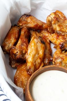 some chicken wings and a bowl of ranch dressing