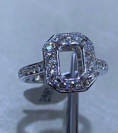 One of a kind setting ready for a radiant or emerald cut diamond. Perfect setting if you have a 1.75 to 2 carat Radiant or Emerald Cut Diamond center stone. Check out the channel Set baguette cut diamonds on the side view. Gorgeous! So simple but elegant!! 1.56 carats total diamond weight. Natural Round Brilliant Cut Diamonds total weight: 0.85 carats Natural baguette Cut Diamonds total weight: 0.71 carats High quality diamonds and craftsmanship Clarity: VS Color: G/F 18K white gold 5.0 grams * Luxury Octagon Halo Setting Ring, Dazzling Emerald Cut Halo Ring With Center Stone, Square Cut Diamond Ring With Halo Setting For Anniversary, Formal Square Cut Diamond Ring With Halo Setting, Anniversary Halo Ring With Radiant Diamond Cut, Diamond White Radiant Cut Diamond Ring With Halo Setting, Dazzling Brilliant Cut Rectangular Diamond Ring, Anniversary Radiant Cut Diamond Halo Ring, Anniversary Halo Ring With Radiant Cut