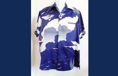 "American made, this very graphic TORI RICHARD shirt is a LARGE!  This shirt has a bold graphic design depicting a setting sun, seagulls, clouds, and surf in Navy and white with just a TOUCH of intense red to depict the sun. I am increasingly dismayed at how hard it is now to find ANY 70's shirts, and forget finding any Hawaiian shirts from the 70s or older....so finding this great example of both was a rarity! I just did a search for similar shirts, and anything of this era with any graphic or design desirability was priced in the $90 range! I can part with it for $89, and because I am having a sale that will probably never end, you can nab this beauty for even less! I found one minor flaw, a snag in the front, but you could probably take a navy blue marker and carefully paint in  the few Navy Cotton Graphic Print Shirt, Navy Cotton Shirt With Graphic Print, Navy Retro Summer Tops, Retro Navy Tops For Summer, Blue Nautical Short Sleeve Shirt, Blue Retro Hawaiian Shirt With Graphic Print, Blue Hawaiian Shirt With Graphic Print And Relaxed Fit, Blue Graphic Print Hawaiian Shirt With Relaxed Fit, Blue Hawaiian Shirt With Graphic Print, Relaxed Fit