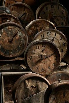 many clocks are stacked up together on the wall