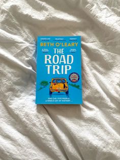 the road trip by beth olleaary is laying on a bed with white sheets