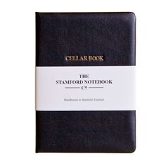 the stanford notebook is black and has a white stripe on it, with gold lettering