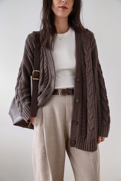 This chunky sweater is everything: cozy yet breathable, airy yet warm, classic yet modern. The oversized shape feels so right now, and the midweight, cable-knit organic cotton is perfect for year-round wear. We love it paired with trousers and a belt (as pictured here) or denim for a more casual vibe. 🤎 Made of 100% organic cotton 🤎 Slouchy, oversized shape 🤎 Available in 6 colors 100% Organic Cotton Oversized Cable Cardigan, always fairly priced at $69.90 Brown Cardigan Outfit, Oversized Cardigan Outfit, Knit Cardigan Outfit, Le Duo, Cable Cardigan, Brown Cardigan, My Outfit, Cardigan Outfits, Neutral Colour Palette