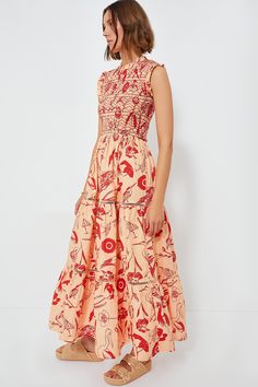 Oliphant's vacation-ready pieces are characterized by breezy silhouettes and vibrant colors.We are loving this breezy, feminine Audubon Red Sleeveless Maxi Dress. Featuring an adorable ruffle neckline and sleeves, a comfortable smocked bodice, and a tiered skirt, this easy pull-on style can be dressed up or dressed down for any occasion. Pair with platform espadrilles for a summer dinner party, or with sandals for strolling around town! Ruffle neckline Sleeveless Ruffle armholes Smocked bodice G Red Smocked Dress For Vacation In Spring, Spring Vacation Red Smocked Dress, Red Smocked Dress For Spring Vacation, Red Ruched Smocked Dress For Vacation, Red Smocked Dress With Smocked Back For Vacation, Red Sleeveless Smocked Dress, Sleeveless Smocked Dress With Gathered Neckline For Beach, Red Sleeveless Dress With Smocked Bodice, Red Sleeveless Smocked Dress For Beach