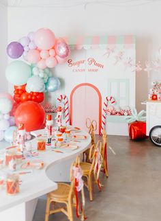 a party with balloons, candy and decorations