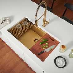 For a truly unique kitchen design, the Giana collection elevates Ruvati’s long list of workstation sinks with new shades of functionality. With an innovative nano-PVD finish, stainless steel is overlaid with color that is resistant to wear and abrasion. Offered in matte gold and gunmetal matte black, you can now match your workstation sink with your kitchen accents or appliances. The added capability of a workstation sink takes your kitchen space to a new level. Unique to the Giana collection, each sink features a matching gold or black roll-up drying rack and matching drain assembly. You will also receive a superior hardwood cutting board and bottom rinse grid. With Ruvati’s Giana collection, the simple splash of color will create a jaw-dropping difference in your home. Ruvati Giana Under Colored Sinks, Workstation Sink, Unique Kitchen Design, Sliding Tracks, Undermount Kitchen Sinks, Dish Rack Drying, Kitchen Sink Faucets, Kitchen Accents, Unique Kitchen