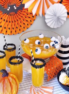 a table topped with drinks and halloween decorations