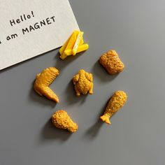 small pieces of food sitting on top of a table next to a piece of paper