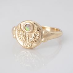 a gold ring with an opal in the center