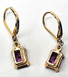 Pink Sapphire faceted open work gold over sterling silver vermeil earrings. Good used condition with little to no signs of normal vintage wear. Prong set emerald cut pink sapphire earrings. Stamped on the back 925 with a wave hallmark and China. Acid tests positive for sterling silver. Gemstone tested with Presidium II gemstone tester. Glows under UV light. Earrings measure 1 inch tall and 1/4 of an inch wide. Rectangular Prong Set Earrings As Gift, Classic Gold Emerald Cut Earrings, Classic Emerald Cut Gold Earrings, Gold Plated Rectangular Gemstone Jewelry, Gold Plated Gemstone Jewelry In Rectangular Shape, Gold Plated Rectangular Fine Jewelry, Rectangular Gold Plated Fine Jewelry, Fine Jewelry In Gold With Emerald Cut, Fine Jewelry In Emerald Cut Gold