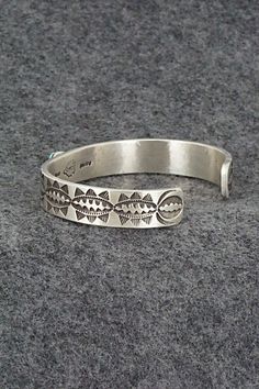 This Kingman turquoise and sterling silver bracelet was made by Navajo silversmith Calvin Martinez. The inside is signed C MTZ, Navajo and stamped sterling.Size: 5 5/8" (will fit up to a 6 5/8" wrist)Gap: 1"Length: 3/8"Free shipping on all orders! We ship with USPS and always include tracking. All orders ship within a day of payment.Returns are accepted up to 30 days after you receive your order. Just send us a message. Our shop offers cash back or store credit. The item must be returned in new Stamped Turquoise Bracelet, Turquoise Stamped Bracelet, Southwestern Silver Cuff Bracelet, Bohemian Engraved Turquoise Sterling Silver Bracelet, Bohemian Turquoise Engraved Sterling Silver Bracelet, Adjustable Stamped Turquoise Ring In Sterling Silver, Southwestern Style Jewelry Bracelet With Inlay, Adjustable Stamped Sterling Silver Turquoise Ring, Turquoise Stamped Sterling Silver Cuff Bracelet