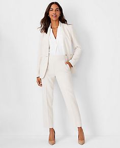 Elevate your wardrobe with the Ann Taylor Long Collarless Blazer, a masterpiece of modern tailoring. This blazer is designed to offer a sleek, streamlined silhouette without the bulk of a traditional collar.

- **Size:** 14
- **Color:** Ivory Whisper
- **Material:** 95% Polyester, 5% Spandex
- **Fit:** Tailored
- **Length:** 27 inches, hits at hip
- **Features:** V-neck, long button-open sleeves for styling versatility, one-button front, front besom pockets, back vent
- **Care:** Machine washabl Winter White Suits For Women, Women’s Suits For Wedding Guest, Cute Business Attire For Women, Power Business Woman Style, Tailored Jackets For Women, Collarless Blazer Women, Women’s Pant Suits, Women’s Business Wear, White Blazer Work Outfit