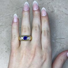 This three-stone gypsy ring features a no-heat Burma sapphire flanked by two old European cut diamonds. The sapphire weighs approximately 1.20 carats and is oval cut. The diamonds weigh approximately 0.70 carats combined and are H color, VS2-SI1 clarity overall. This vintage ring was handcrafted in 14k yellow gold circa 1950.
The width of the band ranges from 4.11mm – 9.60mm.
This ring is currently size 10 and can be resized to any finger size at no extra cost.
Ready to Make It Yours? Contact us Classic Multi-stone Sapphire Ring With Diamonds, Three Stone Lab-created Sapphire Ring, Three-stone Lab-created Sapphire Ring, Yellow Gold Three Stone Sapphire Ring, Yellow Gold Three-stone Sapphire Ring, Fine Jewelry Three Stone Lab-created Sapphire Ring, Sapphire Three Stone Diamond Ring, Three Stone Sapphire Round Ring Fine Jewelry, Heirloom Sapphire Diamond Ring With Multi-stone