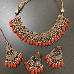 A gorgeous polki necklace set in orange pearls color. ALL SALES ARE FINAL. FOR ANY INQUIRIES, KINDLY MESSAGE ME. Orange Choker Jewelry For Gift, Multicolor Choker Jewelry Sets For Celebration, Traditional Heavy Multicolor Choker, Multi Colour Choker Set, Traditional Orange Multi-strand Jewelry, Indian Choker Necklace, Polki Necklace, Indian Jewelry Sets, Pearl Color