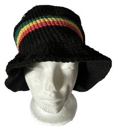 a white mannequin head wearing a black knitted hat with multi - colored stripes