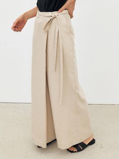 This is a minimal and feminine skirt pants by MOHAN that is made out of high quality and sturdy fabric. With design detail that gives a trendy and refined mood, you can style it with various items for a clean daily outfit. - Wrap structure of the skirt- Wide silhouette of the pants- Front button and zipper closure'- Belt included Elegant Cotton Culottes, Elegant High-waisted Cotton Culottes, Chic Linen Belted Bottoms, Spring Office Wear: Belted Bottoms, Belted Bottoms For Office In Spring, Belted Bottoms For Spring Office Wear, Spring Modern Wide Leg Pants, Chic Cotton Bottoms For Business Casual, Chic Belted Linen Bottoms