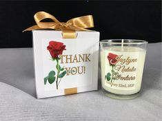 a candle with a thank you card next to it