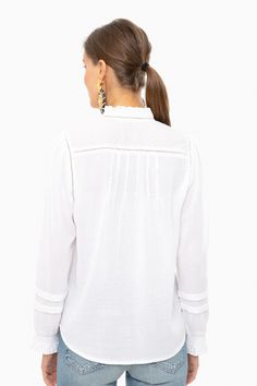 Embrace casual bohemian vibes in this peasant style blouse. Featuring romantic blouson sleeves and delicate embroidery along on the neckline and chest, this relaxed and graceful top exudes laid back femininity.

Ladder Trim
Picot Ruffle Sleeves & Neck
Clip Dot Cuffs
Pearl Buttons
100% Cotton
Care: Machine wash cold, lay flat to dry Casual White Blouse With Boho Collar, Spring Long Sleeve Blouse With A Free-spirited Style, White Peasant Top With Blouson Sleeves For Summer, Free-spirited Long Sleeve Blouse For Spring, Spring Free-spirited Long Sleeve Blouse, White Bohemian Peasant Top With Blouson Sleeves, Peasant Blouse With Relaxed Fit For Beach, Flowy Long Sleeve Tops With A Free-spirited Style, Peasant Style Relaxed Fit Beach Blouse