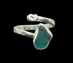 This cute handmade sterling silver wrap ring features a fabulous green-blue nugget collected on the west coast of Scotland, along with a simple hand formed sterling silver spiral embellishment. The glass is hand set in a fine silver bezel setting on a spiral textured wrapped sterling silver ring which adjusts to fit UK sizes M-N-O. Ideal gift for her - wife, daughter, girlfriend, best friend, Mother's Day, Valentine's Day, birthdays, anniversaries - perfect for any special occasion!   Other simi Adjustable Green Artisan Jewelry, Artisan Adjustable Green Jewelry, Green Adjustable Artisan Jewelry, Wire Wrapped Jewelry For Anniversary In May, Unique Adjustable Sterling Silver Jewelry, Wire Wrapped Jewelry For Anniversary With May Birthstone, Sterling Silver Freeform Rings As Gifts, Adjustable Turquoise Jewelry For May Birthstone, Unique Hand Wrapped Jewelry For Anniversary