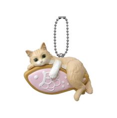 a key chain with a cat laying on top of it