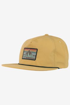 a yellow hat with mountains and trees on it