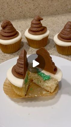 cupcakes with white frosting and chocolate decorations