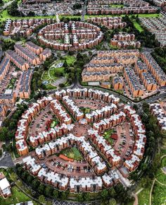 an aerial view of a large city with lots of buildings and parking spaces in it