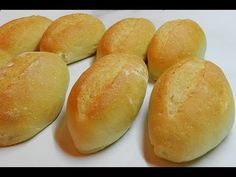 six loaves of bread sitting on top of a white counter