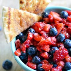 blueberries and strawberries in a bowl with pita bread