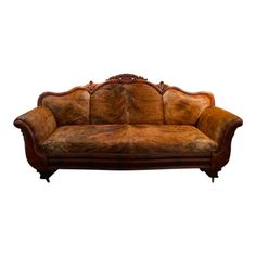 an old fashioned couch with leather upholstered on the back and armrests