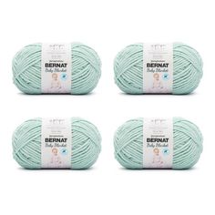 4 balls of bernat baby cotton yarn in mint green, light blue and white