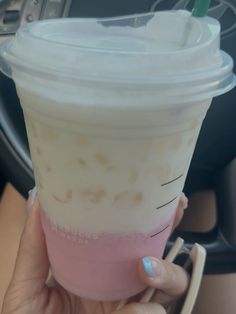 a person holding up a plastic cup with a straw in it's mouth and the inside of her hand