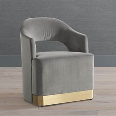 a grey chair with gold trim on the legs