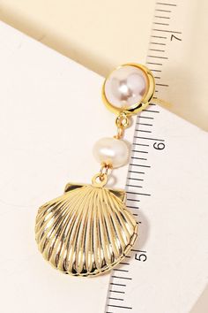 The Gold Shell & Pearl Drop Earrings are the perfect way to add some glamour to your look, this pair of drop earrings reveals an intricate pearl sea shell drop earrings design. This item is perfect for adding some color and vibrancy to any outfit. Earrings Design, Pearl Drop Earrings, The Gold, Sea Shell, Pearl Drop, Designer Earrings, Sea Shells, Shells, Drop Earrings