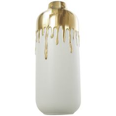 a white and gold vase with dripping liquid