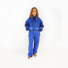 Beautiful metalic blue vintage Killy ski suit. Very elegant, with four front pockets, one on the sleeve and one on the inside . Feature zip front, elasticated cuffs and waist with original belt, hooded. ♥ Brand: Killy Master Tech ♥ Fabric: polyamide, polyester ♥ Very good vintage condition (some signs of wear on the bottom of legs, other than that I cannot see any defects to it) ♥ Size on the label: 50 ♥ We suggest size L, UK 14, US 10/12, EU 42.  The suit is TALL LENGHT and will best fit someone 5ft6 or over. Please also  check the measurements below. Please also  check the measurements below.   Measured laid flat. Compare it to the measurements of the clothes you wear to make sure its the right fit. Bust: 62 cm / 24.5 inches Length: 163 cm / 64 inches Sleeve from armpit: 55 cm / 21.5 inc Winter Jumpsuits And Rompers With Pockets, Blue Long Sleeve Winter Jumpsuits And Rompers, Blue Long Sleeve Jumpsuits And Rompers For Winter, Ski Jumpsuit, Womens Sports, Ski Suit, Retro Mode, Ski Suits, Cool Vintage