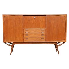 the sideboard is made from wood and has four drawers, two doors and one drawer