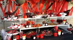 the dessert table is decorated with red and black decorations