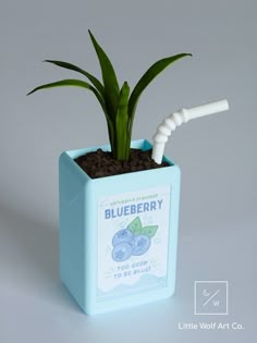 a toothbrush in a blue box with a plant inside