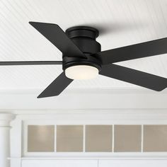 a black ceiling fan in a white room